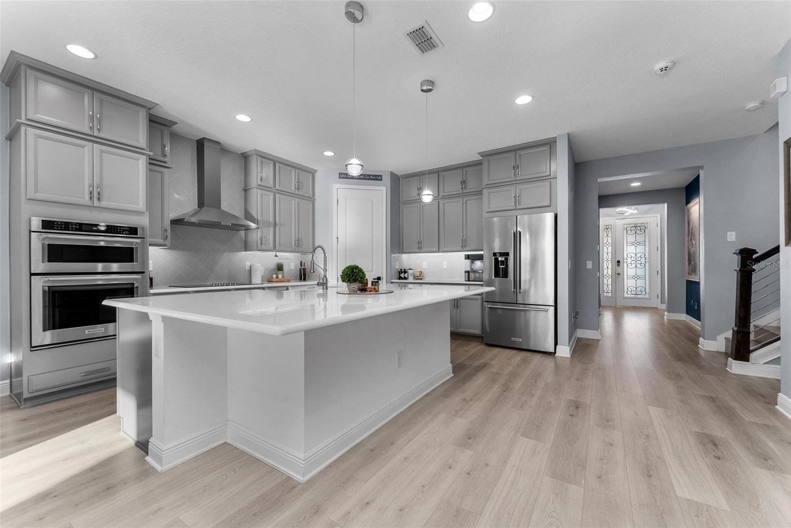 kitchen with grey modern cabinets and large white island
